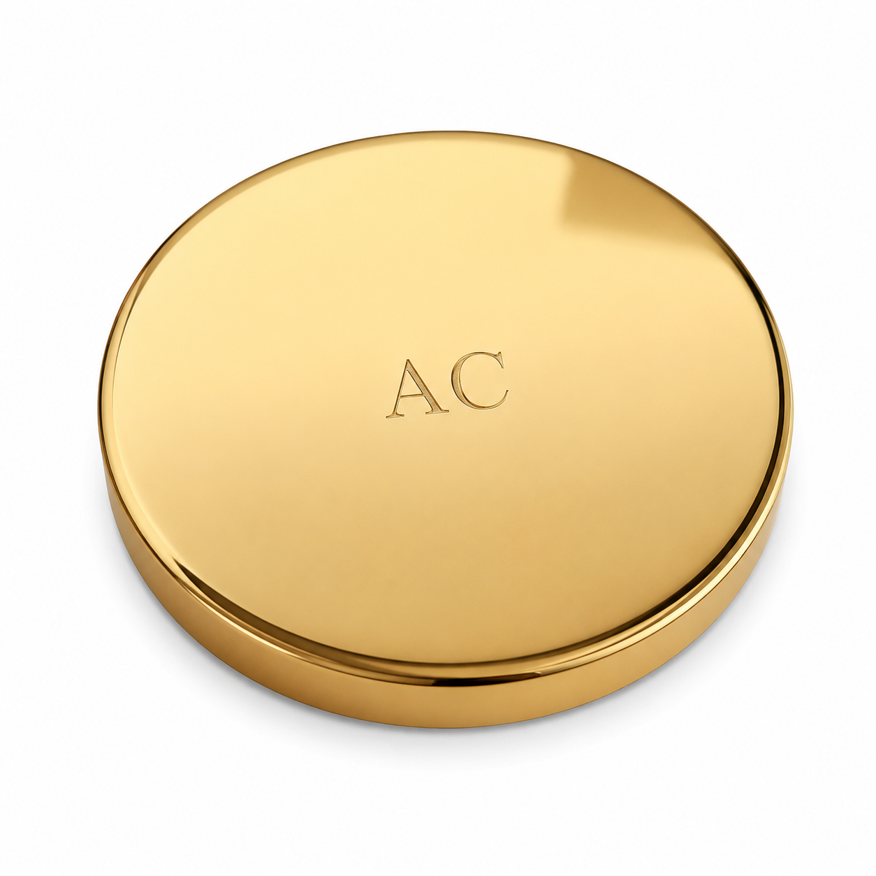 A sleek, round gold candle lid with engraved letters "AC" centred on the lid. The surface reflects light, conveying a sense of luxury and elegance.