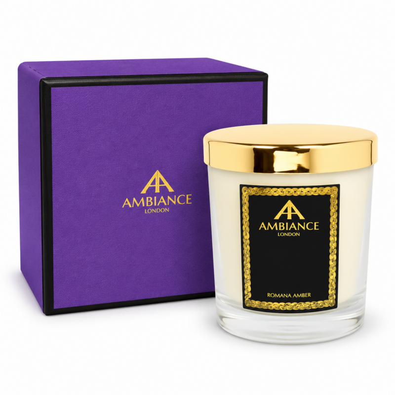 Romana Amber luxury scented candle by Ancienne Ambiance London in a clear glass vessel with a gold lid, presented with a purple Ambiance London gift box on a white background.