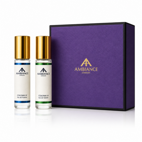Two Ancienne Ambiance London perfume bottles with golden caps sit beside a purple box. The bottles evoke elegance and luxury.