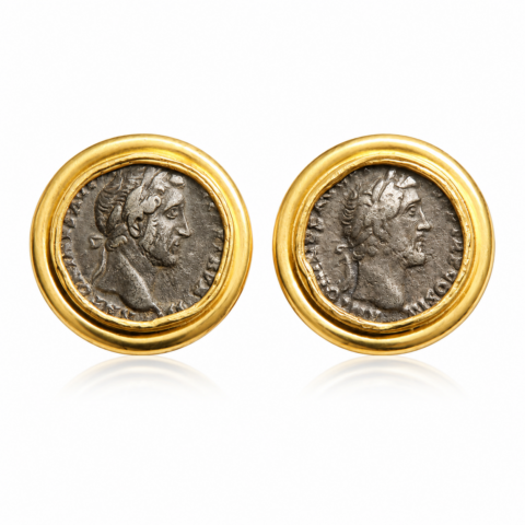 A pair of earrings with ancient silver Roman coins encased in gold settings. Each coin features a profile of a Emperor Antoninus Pius in relief.