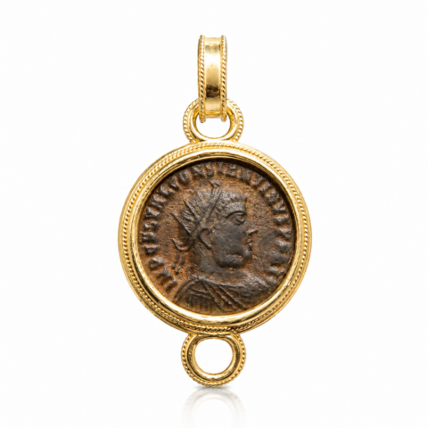 Ancient Roman coin set in gold round frame pendant, featuring a profile of an emperor. The coin has a rustic, historical look.