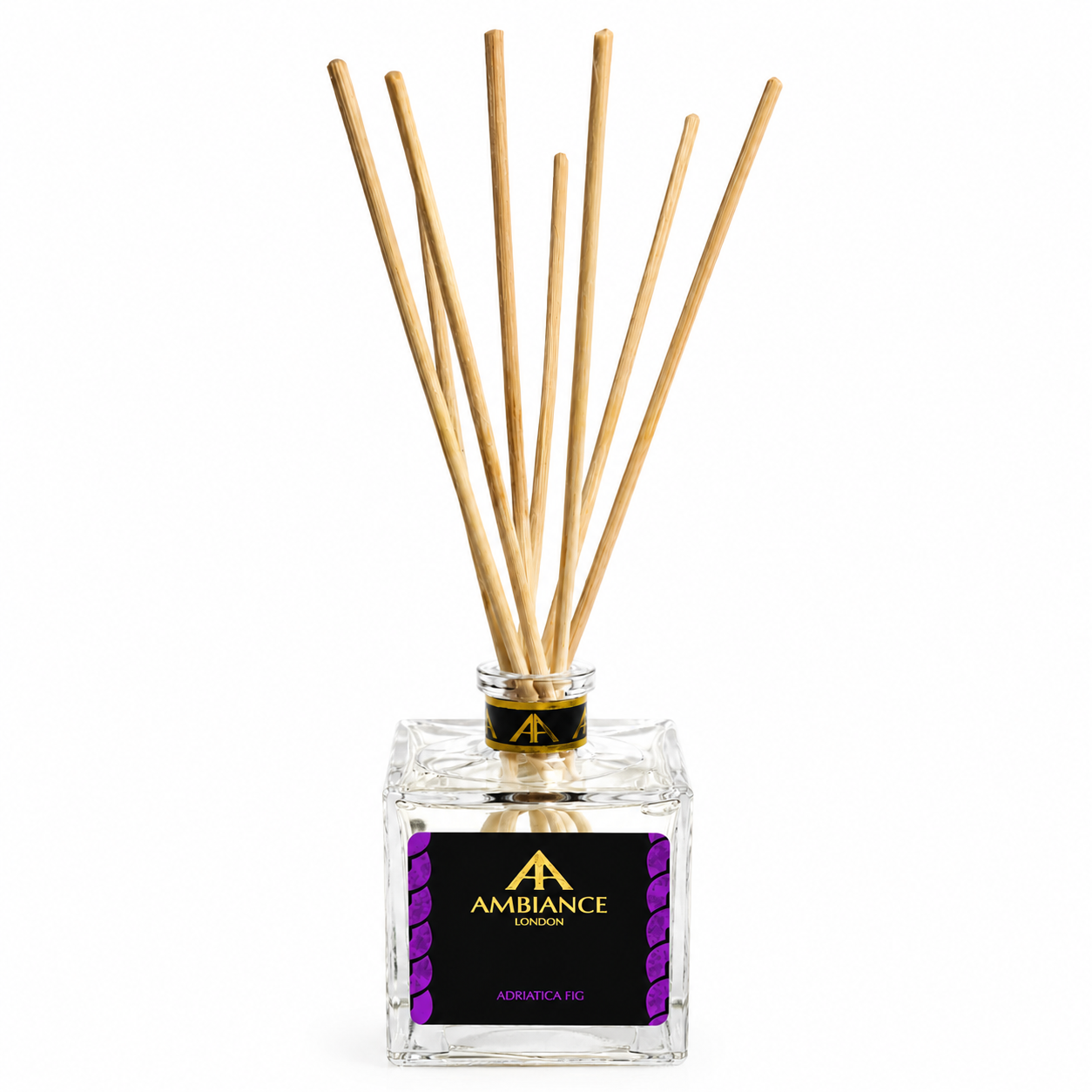 Clear glass reed diffuser with wooden sticks, labeled "Ancienne Ambiance London" and "Adriatica Fig." The design is elegant, conveying luxury and calm.