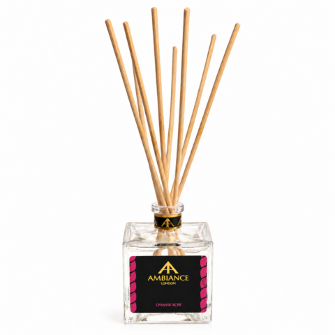 Square glass diffuser bottle with natural reeds and a black label reading "Ancienne Ambiance London Damask Rose," conveying elegance and calm.