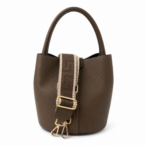 Taupe leather bucket bag with a pebbled finish, featuring a decorative wide strap with a geometric pattern and gold-tone clasps, conveying elegance.