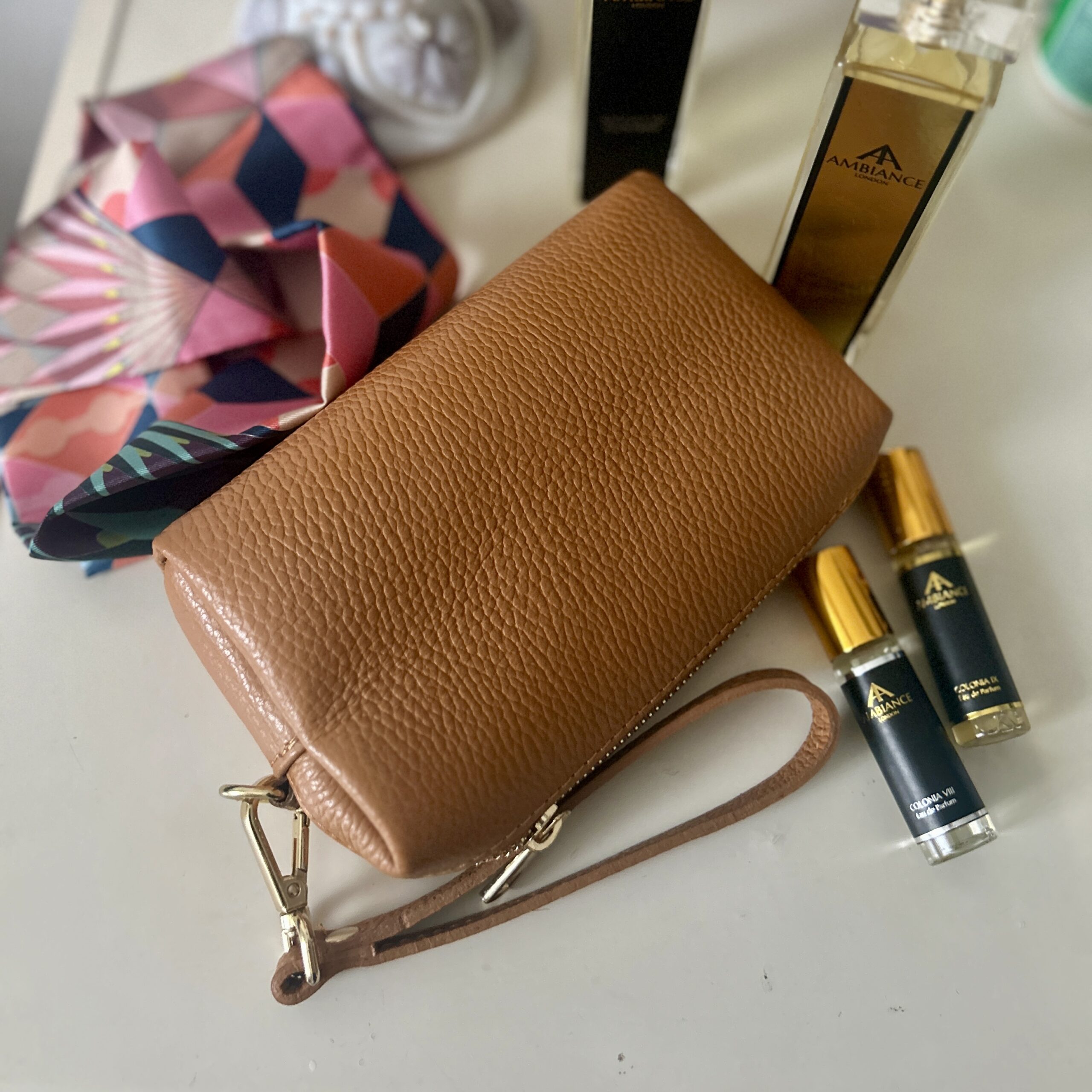 Tan bellezza pochette makeup bag on vanity table