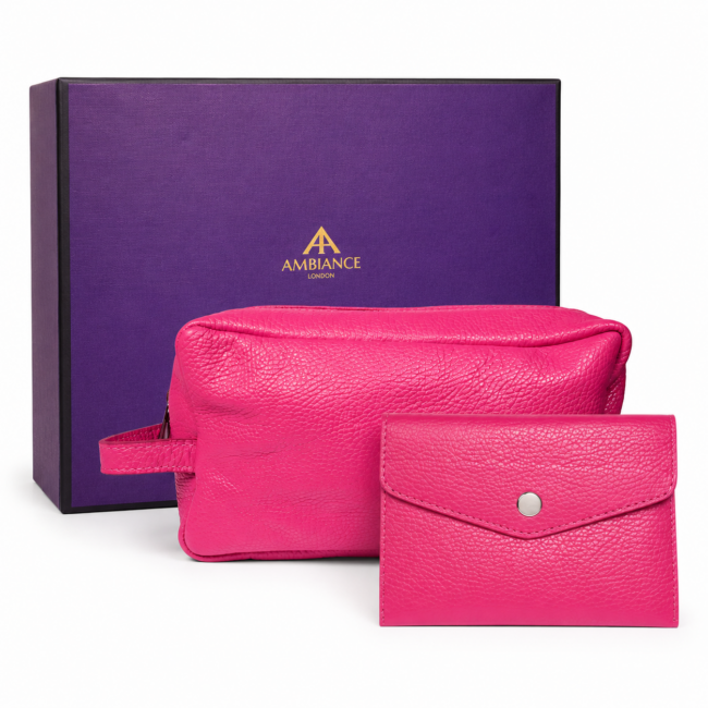 A pink leather pouch and wallet sit in front of a purple box with gold "Ancienne Ambiance London" logo. The image conveys luxury and elegance.