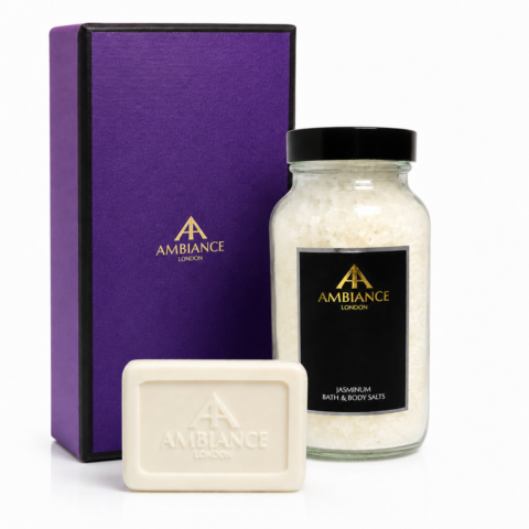 Purple box, glass jar of white jasmine bath salts, and embossed white soap bar elegantly displayed. Ancienne Ambiance London branding; luxurious and soothing tone.