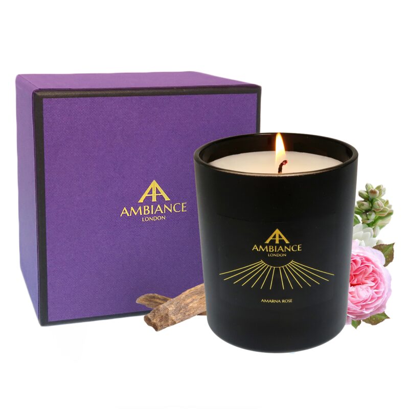 A lit black candle labeled "Ambiance London" sits beside a purple box with the same branding. Pink roses, tuberose and oud wood create a relaxing atmosphere.