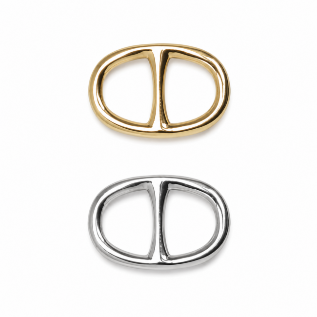 Two interlocking oval-shaped scarf rings, one in gold and one in silver, are displayed on a white background. The design is sleek and modern.