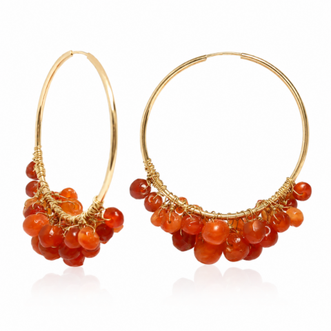 Gold hoop earrings adorned with clustered orange ancient carnelian gemstones, creating a vibrant and elegant design. The warm tones exude a chic and fashionable vibe.