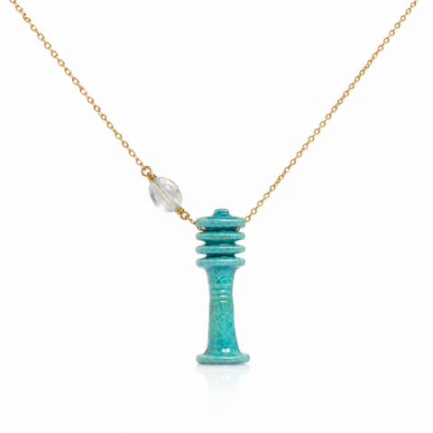 Elegant necklace featuring an ancient Egyptian faience Djed Pillar pendant with a clear aquamarine stone, hung on a thin gold chain. The design is modern and minimalistic.