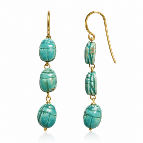Gold dangle earrings with three ancient Egyptian faience scarabs, set against a white background. The design is elegant and conveys an ancient, artistic feel.