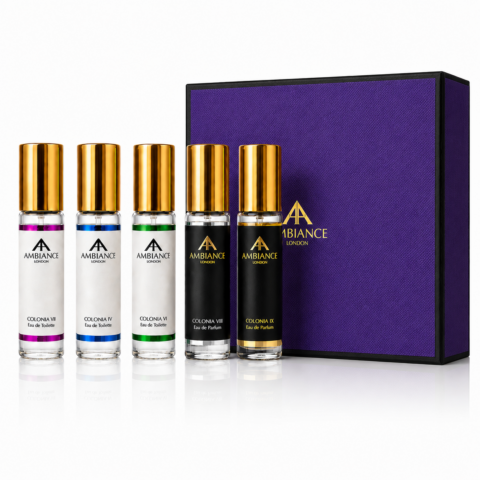 Five perfume bottles with golden caps are aligned in front of a purple box. Each bottle has a different coloured label, creating a luxurious feel.