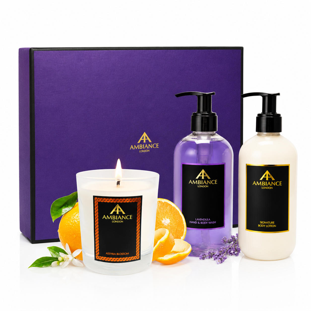 Purple gift box labeled "Ancienne Ambiance London" with a lit candle, hand wash and lotion bottles. Candle features citrus and floral accents; bottles are lavender and cream. Luxurious tone.