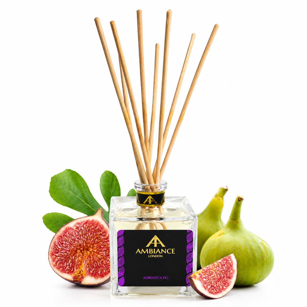 Clear glass diffuser bottle with wooden reeds and "Ancienne Ambiance London" label, surrounded by fresh figs and green leaves, evoking a natural, aromatic feel.