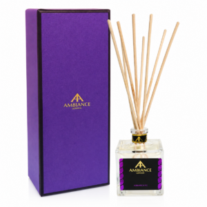Purple box with gold "Ancienne Ambiance London" logo next to a clear Adriatica Fig diffuser bottle with reed sticks. Elegant and luxurious presentation.