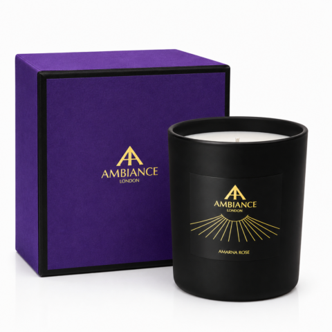 Black "Amarna Rose" candle with "Ancienne Ambiance London" label in gold next to an elegant purple box adorned with the same logo, evoking luxury and sophistication.