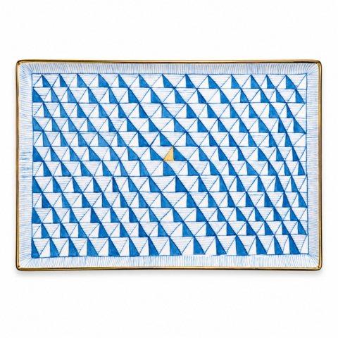 Rectangular porcelain tray with a geometric pattern of blue triangles forming a grid, featuring a single gold triangle at the centre. Edged with a gold rim.
