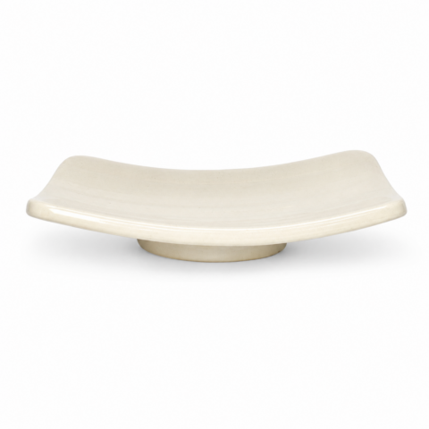 A cream-coloured rectangular soap dish with slightly raised edges sits against a plain white background, conveying a minimalist and elegant style.