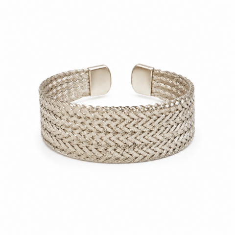 A silver cuff bracelet with a woven chevron pattern and smooth end caps. The shiny texture conveys elegance and simplicity against a white background.