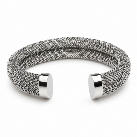 Silver woven bracelet with a thick mesh texture and polished metal end caps, forming an open circular shape. Elegant and modern design.