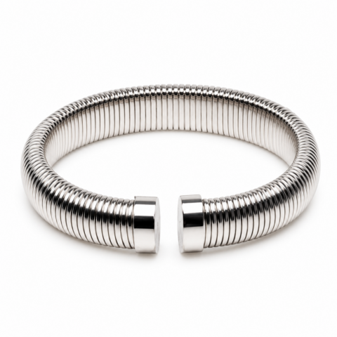 Sleek silver coiled bracelet with a reflective polished finish, open-ended design. Elegant and modern, placed on a plain white background.