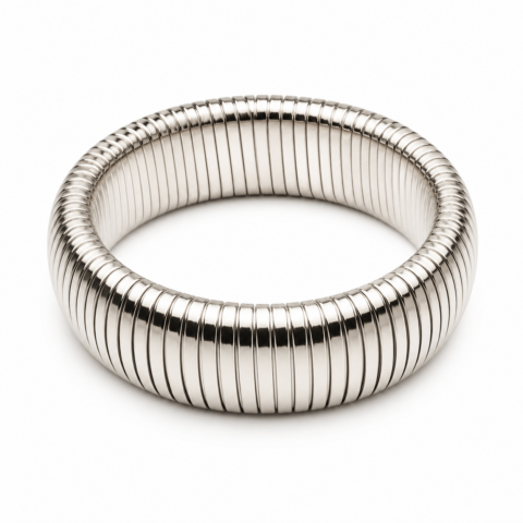 A silver coiled bracelet with a smooth, shiny surface and segmented ridges, forming a complete circle. It conveys a modern, elegant style on a white background.