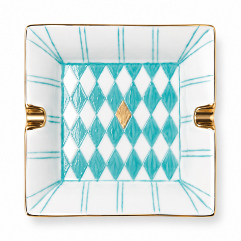Square porcelain ashtray with turquoise and white diamond pattern, featuring a central gold diamond shape. Gold accents and a refined design suggest elegance.