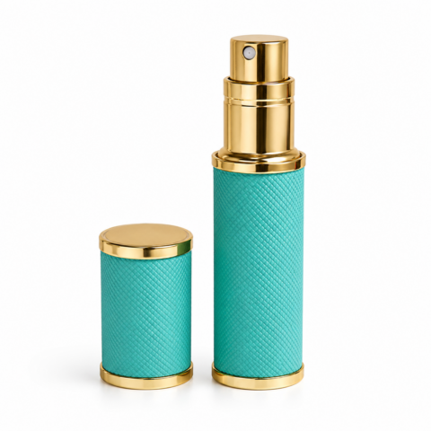 Turquoise and gold textured travel perfume atomizer with a matching cap beside it. The elegant design conveys luxury and sophistication.