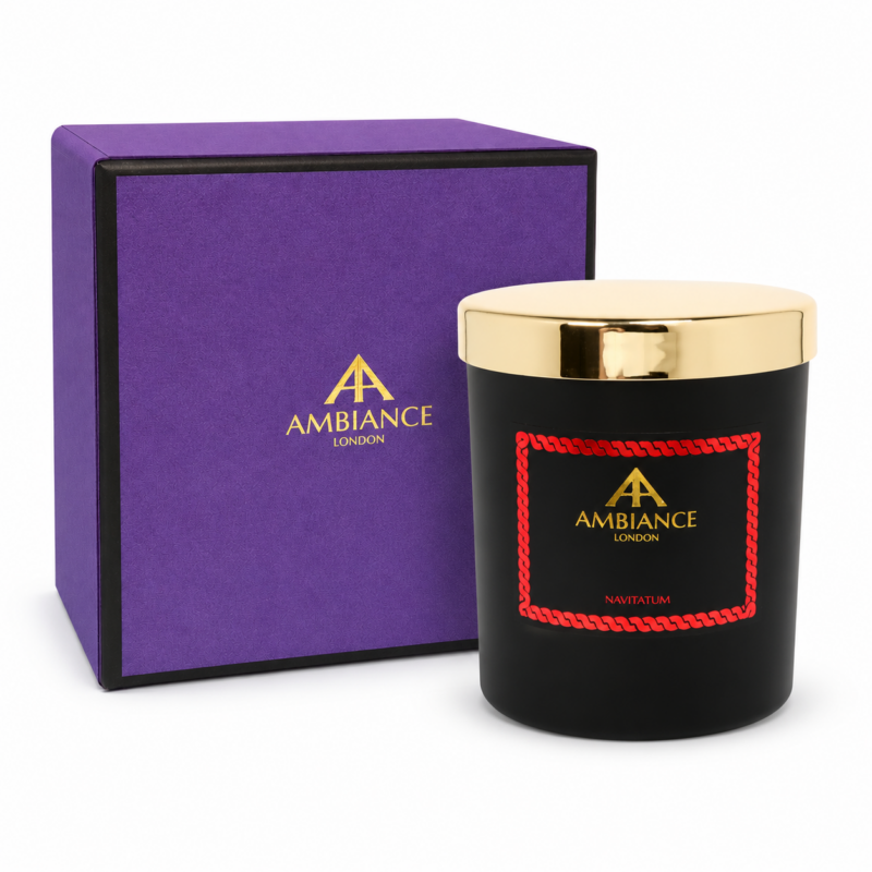 Navitatum scented candle by Ancienne Ambiance London in a matte black vessel with a polished gold lid beside the signature purple luxury gift box.