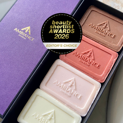Beauty Shortlist Awards 2026 winner – Ancienne Ambiance candle. Four rectangular bars of Ancienne Ambiance London soap in brown, pink, cream and beige are in a box beside a purple lid. A "Beauty Shortlist Awards 2026 Editor's Choice" badge is on top.