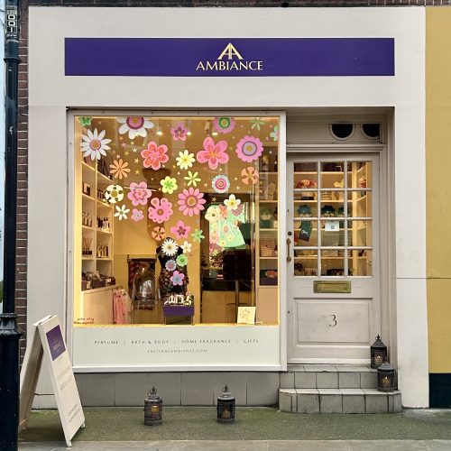 Ancienne Ambiance London shop front with Mother's Day floral pop art window painting and showcase of luxury gifts.